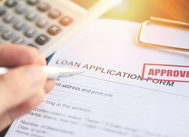 Loan application with an 'Approved' stamp
