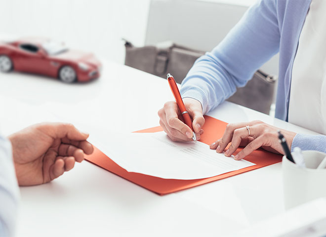 Driver signing a car loan