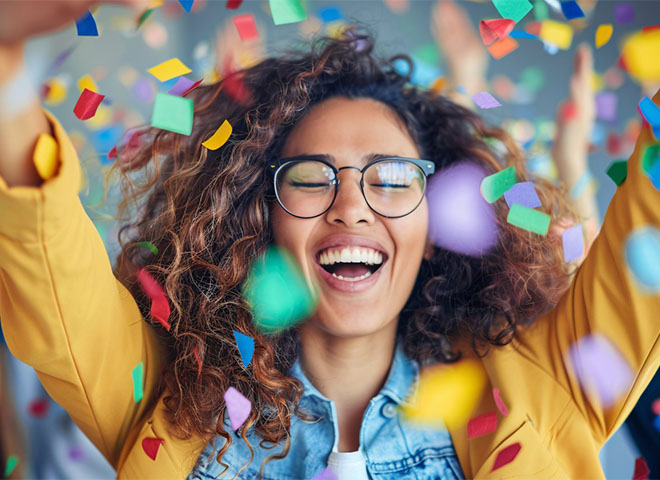 Confetti flying around a woman celebrating