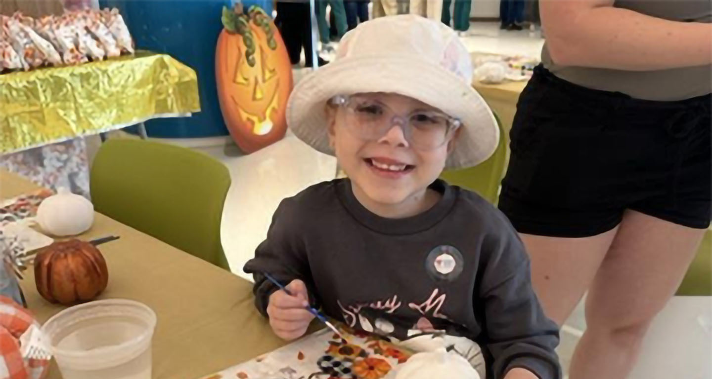Child at painting station at Nicklaus Children's Hospital