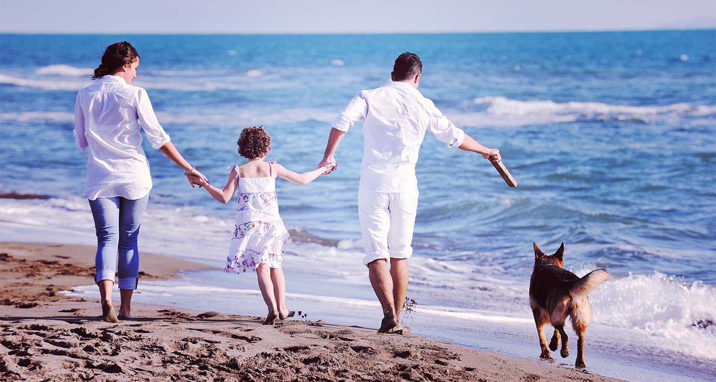 Family on the beach with their dog