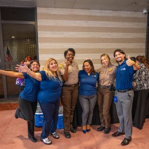 Four representatives of DCFCU smiling with two women who are Miami-Dade County Police officers