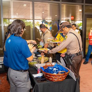 DCFCU reps and Miami-Dade Police Officers getting food from table