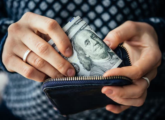 Man placing money in a wallet