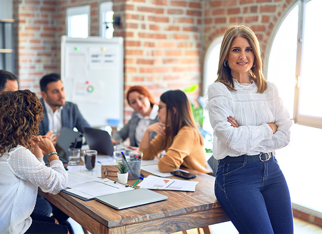 Female business owner with employees in office