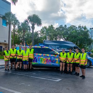Group photo of volunteers in yellow high-visibility vests
