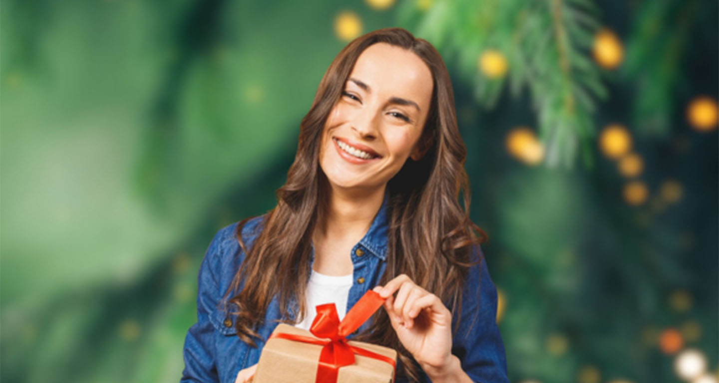 Smiling woman holding a Christmas gift