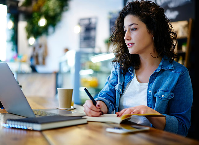 Woman banking on laptop at coffee shop